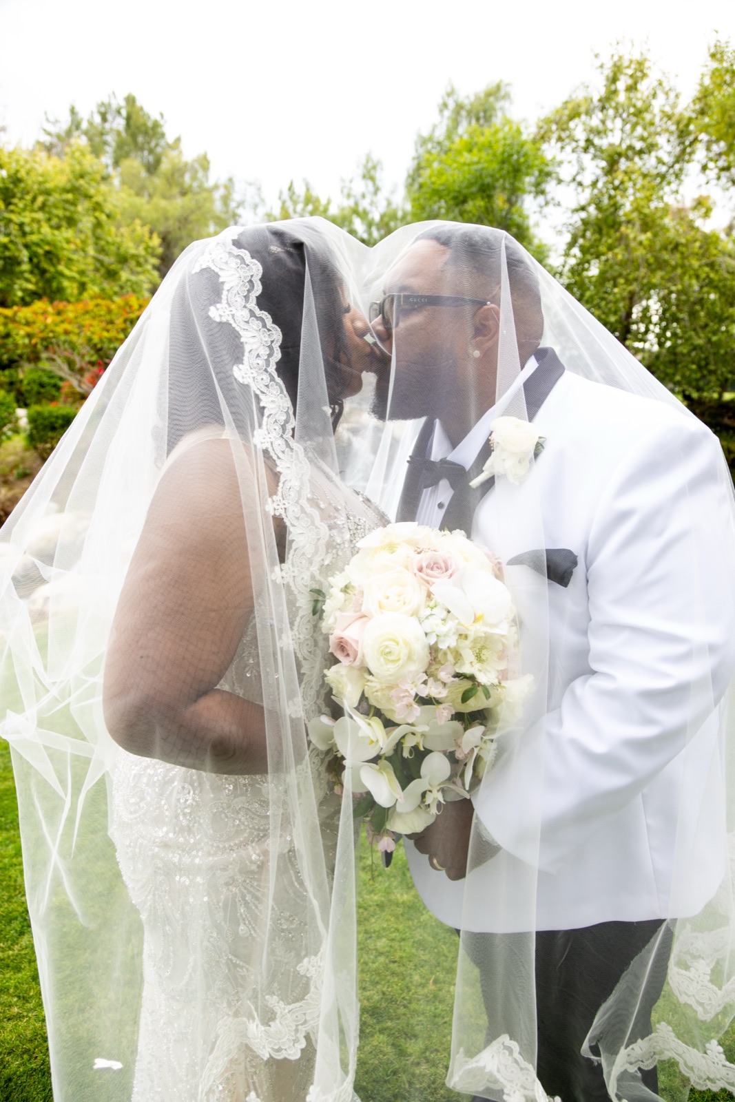 Couple sharing a kiss under the veil